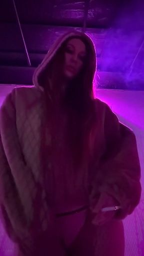 Smoking a Cigarette Outdoor While Wearing Only a Bikini and a Jacket