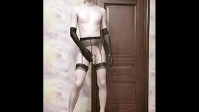 Crossdresser in a cage fucks with a dildo and poses naked