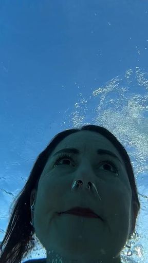 Slow motion swim in public pool in vintage one-piece swimsuit