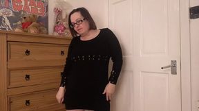 Seductive strip-tease in sleek black wool mini dress