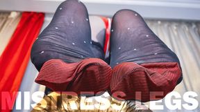 Foot tease in black nylons with white polka dots and red reinforced toes