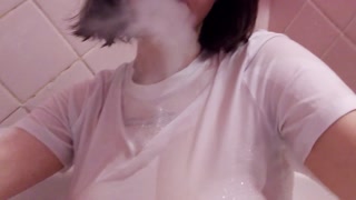 having fun in the bathtub with foam in a wet white top. I smoke and listen to 2rbina2rists