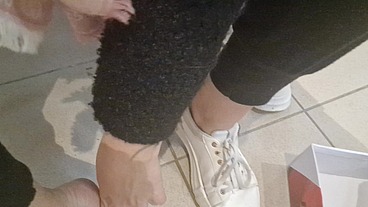 Dirty sneakers dirty feet in a public store 4K