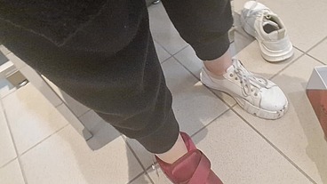 Dirty sneakers dirty feet in a public store 4K