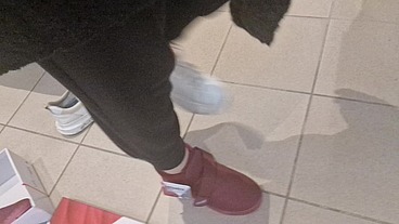 Dirty sneakers dirty feet in a public store 4K