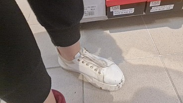 Dirty sneakers dirty feet in a public store 4K