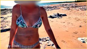 Beachside wife shows off her knockers in a provocative public strip tease