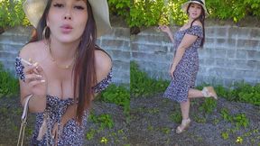 How nice to smoke outdoors in this pretty dress on a summer day