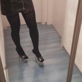 crossdresser in stripper high heels stockings and latex mini