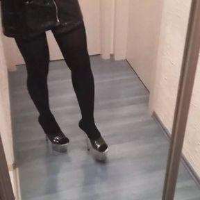 crossdresser in stripper high heels stockings and latex mini