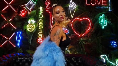 Monika Fox teases her tattooed body with massive dildos in a neon-lit fetish lounge