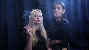 Two Women Smoking Together in a Dark Studio with Soft Blue Lighting