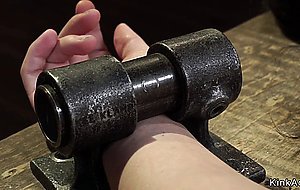 Shackled in metal device brunette babe