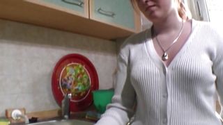 A wild German chick gets her small tits covered with cum in the kitchen