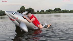 Hot sex with orgasm of a rare inflatable shark on a lake in a red inflatable safety vest