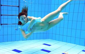 Skinny redhead teen mistress in the pool naked on cam