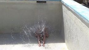 Two brothers play naked with water in Valencia pool