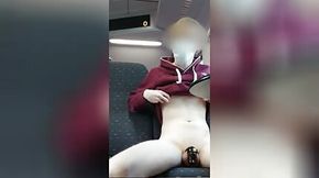 Boy in chastity plays with buttplug on the train