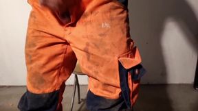 Construction worker squirts on his Hi-Viz worker trousers