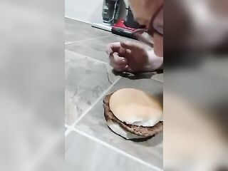 Chubby big beautiful woman piggy eating burger off the floor hands-free
