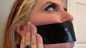 cute redhead dirty talks through her duct tape gag!