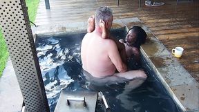 Dripping wet ebony milf gives boss a steamy handjob in the hottub
