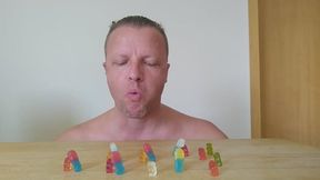 A giant is swallowing gummy bears and smurfs