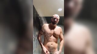 Bearded Swimmer showers in locker guest room
