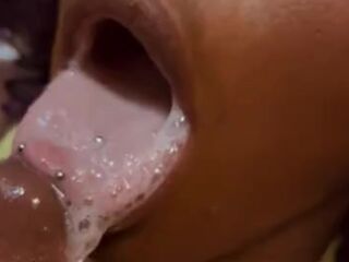 Black Teen playing with a mouth full of cum