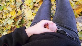 Femboy draining off outside in the fall leaves