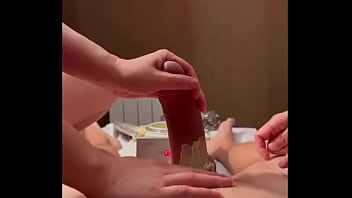 Busty Asian masseuse gives double handjob with well-waxed cock