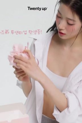 Slim Korean beauty influencer reviews skincare product in her bathroom
