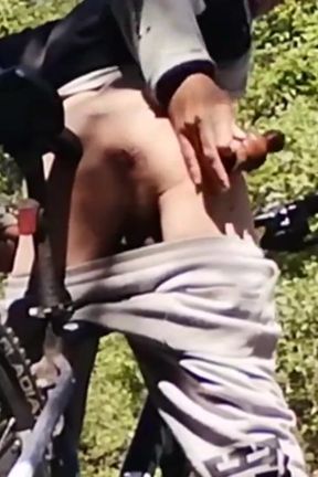 Slim boy with his bike in the park