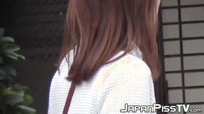 ”Japanese girl takes off her dress to piss outside in public”