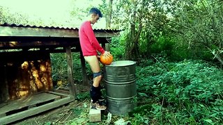 Teenager is hard banging a pumpkin in the garden