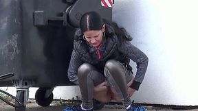 Nasty dark haired slut pisses near trash box outdoors