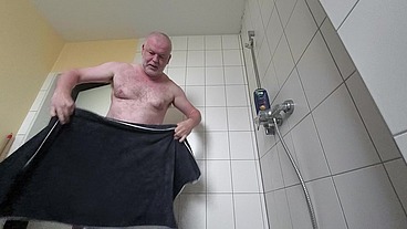 Dicker Mann rasiert sich Haare am Kopf