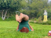 Pelirroja hace estiramientos sensuales de Yoga en el parque para que la observen