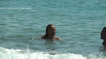 Naked ladies are relaxing on the beach knowing that people might be staring at them