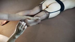 Sexy woman in long nylon socks gets her feet tickled and massaged.
