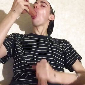 A young virgin sucks a dildo and jerks off his penis until he cums on his T-shirt