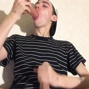 A young virgin sucks a dildo and jerks off his penis until he cums on his T-shirt