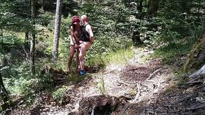 Milf woman with big tits jerking fat dick in the woods