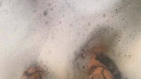 Tattooed MILF rubs oil on massive tits and feet before riding dildo