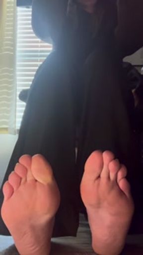 candid removing dirty socks under desk to reveal tasty soles during work