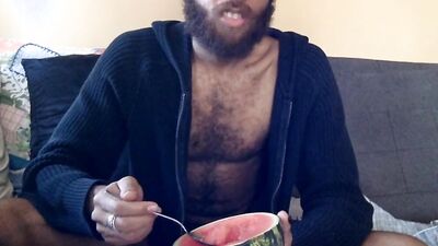 Hairy guy eats a watermelon wearing nothing but sexy robes