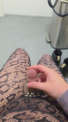 Sissy caged femboy cums in public bathroom