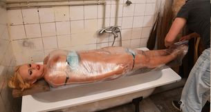 Vicky wrapped in plastic and gagged