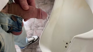 Guy peeing in public office toilet
