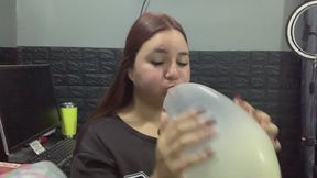 Jen blows and spits a lot into the balloon